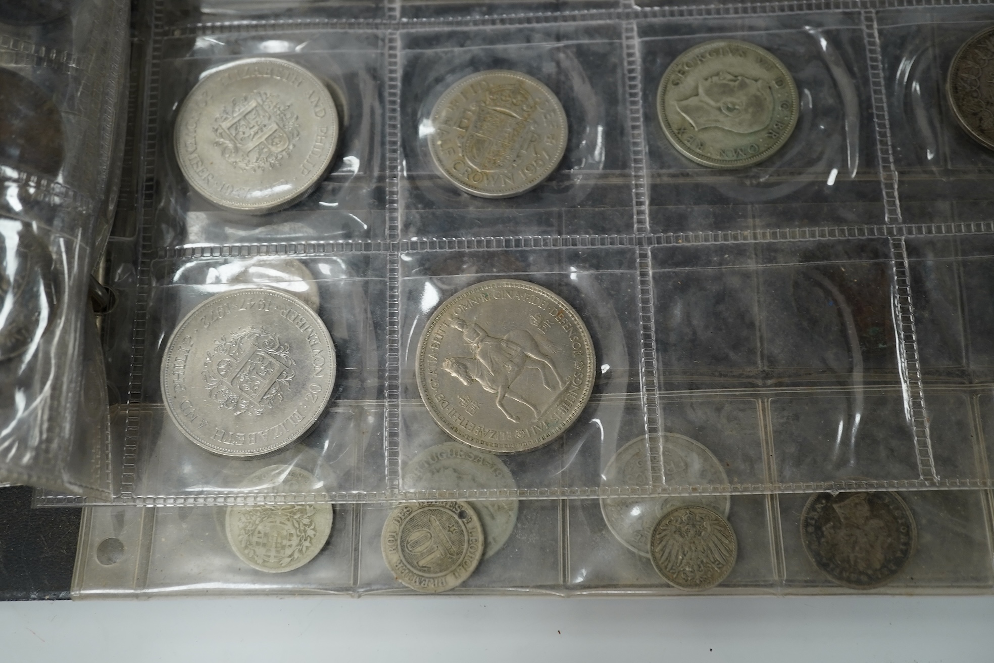 A collection of various coinage in an album, mostly George V to QEII